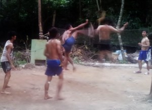 Locals playing a crazy game  that combines Soccer and Volleyball 