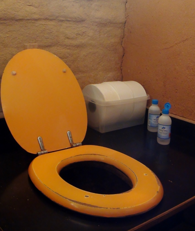 The best compost toilets ever! Notice the piece of wood preventing the toilet lid from hitting the wall. German engineering!